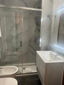 a bathroom with a shower and a sink and a toilet at Liberty Vatican Suites - Liberty Collection in Rome