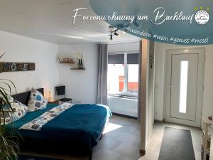 a bedroom with a bed with a blue comforter at Ferienwohnung Am Bachlauf in Pommern
