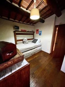 a bedroom with a bed with a laptop on it at Pergaccio Deluxe House in Cortona