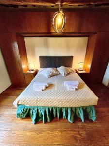 a bedroom with a bed with two pillows on it at Pergaccio Deluxe House in Cortona