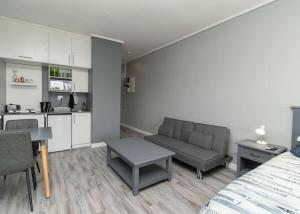 a living room with a couch and a kitchen at 256 @ Brookes's in Summerstrand