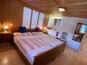 a bedroom with a large bed in a room at Apartment Chalet Im sunnigen Usblick in Wengen
