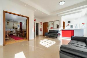 a living room with two couches and a dining room at Hotel Padre Pio by Umbral in Fátima