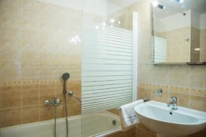 a bathroom with a sink and a tub and a shower at Hostel Little Quarter in Prague +37 photos