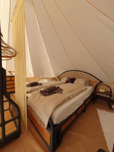 a bedroom with a bed in a tent at Farm Glamping Ráckeve in Ráckeve