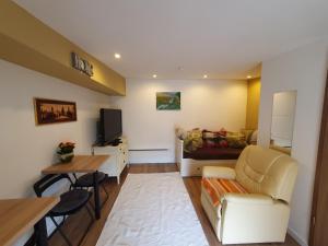 a living room with a couch and a table at Farm Glamping Ráckeve in Ráckeve