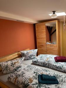 a bedroom with two beds and a mirror at Zur zornigen Ameise in Thale