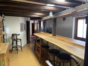 a bar with stools in a room with wooden ceilings at Zur zornigen Ameise in Thale