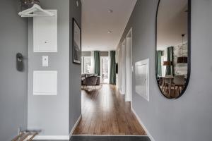 a hallway with a mirror and a dining room at Engeltofta Sea Lodge in Gävle