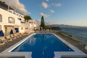 a swimming pool with a view of the water at Karma Minoan in Agios Nikolaos