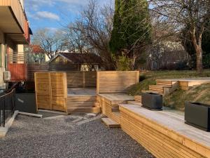 a backyard with wooden steps and a fence at Apartment in Bromma close to Stockholm City in Stockholm