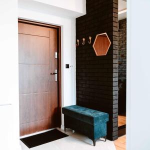 a door with a blue bench next to a brick wall at Apartament LOFT na Moniuszki in Radom +7 photos