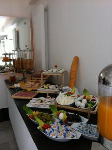 a buffet with many plates of food on a counter at Crystal Hotel in Amman