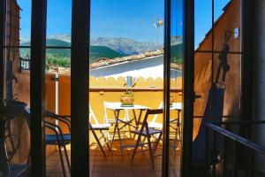 a view of a balcony with a table and chairs at 'La Casa de LoLa' casita de cuento con terraza in Arenas de San Pedro