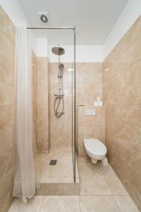a bathroom with a shower and a toilet at Zalgirio Arena Apartment No1 by URBAN RENT in Kaunas
