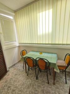 Apartment in Budva في بودفا: غرفة طعام مع طاولة وكراسي