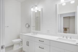 a white bathroom with two sinks and a toilet at South Lake Union 2br w gym roof nr restaurants SEA-554 in Seattle