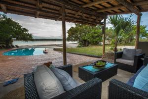 a patio with chairs and a swimming pool at Kosi Forest Lodge in Manguzi