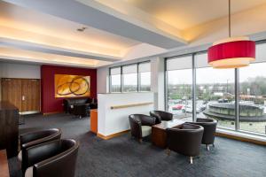a waiting room with chairs and tables and a large window at Holiday Inn Express Hamilton by IHG in Hamilton +54 photos