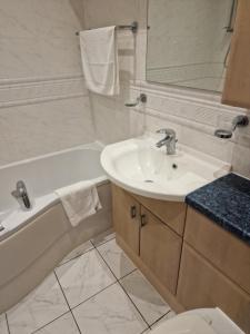 a bathroom with a sink and a tub and a toilet at Tees Valley Apartments in Middlesbrough