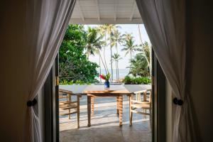 a dining room with a table and a view of the ocean at Bellini Blue in Unawatuna