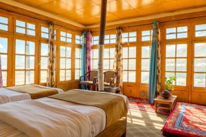 two beds in a room with windows at Astrostays at Pangong in Spangmik +37 photos