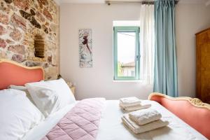 a bedroom with a bed with two towels on it at Queen's stone legend, royal living by Acropolis in Athens