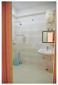 a bathroom with a sink and a shower at Tapovan Resort in Rishīkesh