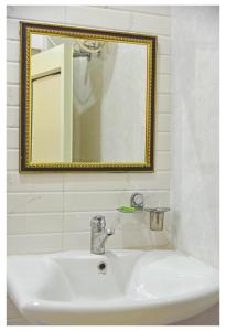 a bathroom with a sink and a mirror at Tapovan Resort in Rishīkesh