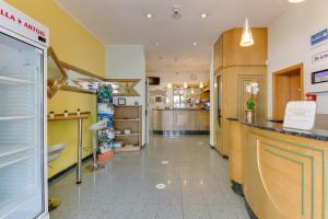 a store lobby with a counter and a pharmacy at Hotel Villa Merope with free coffee in Rimini