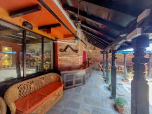 a restaurant with a bench and a bar at Hotel Garuda in Bhaktapur