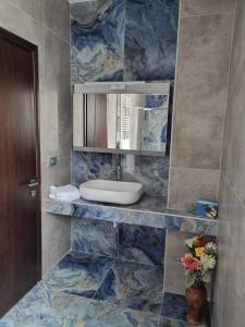 a bathroom with a sink and a mirror at Valentina's Luxe Apartment in Mastichari