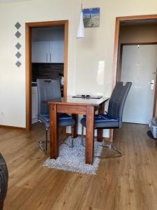 a dining room table with chairs and a desk at Ferienwohnung Schwitzkowski in Glücksburg