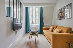 Televízia a/alebo spoločenská miestnosť v ubytovaní Residence Center of Paris by Studio prestige