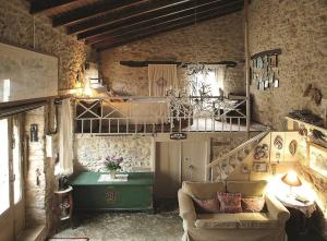 a living room with a couch and a table at "Thimises" traditional-stone village house in Kharasón