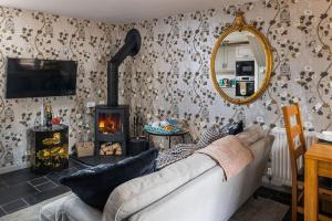 a living room with a couch and a fireplace at Puffin Cottage in Ilfracombe