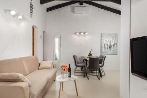 a living room with a couch and a table at Villa Mali Raj in Lopar