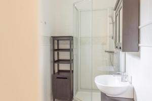 een badkamer met een wastafel en een glazen douche bij Lossirannan Kartano in Huutotöyry