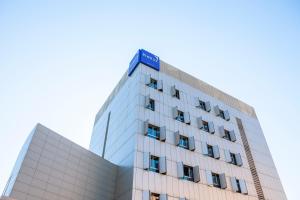 a building with a blue sign on top of it at Porcel Torneo in Seville