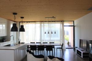 a kitchen and living room with a table and chairs at Ferienhaus am See Neusiedl in Neusiedl am See