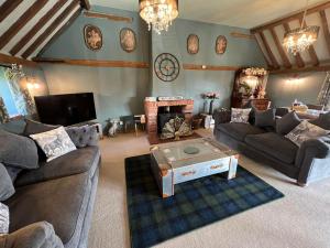 a large living room with couches and a fireplace at Couples retreat Boutique style Barn conversion in Great Yarmouth