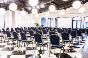 a room with rows of chairs and lights at Hotel Opera in Tarnowskie Góry