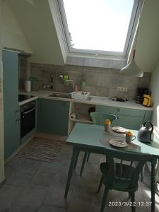 a kitchen with a table and a window in it at Zimmer Frei 3 in Wiesbaden