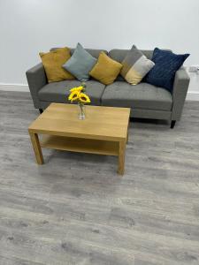 a living room with a couch and a coffee table at Huge studio close to city centre with free secure parking in Leeds