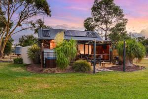a house with solar panels on top of it at Goolwa River Retreat in Torrumbarry