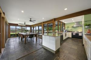 a large kitchen with a table and a dining room at The Wellness Farm Broke in Broke