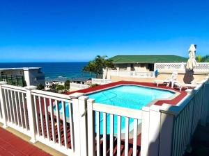 a swimming pool on a balcony with the ocean in the background at Irina House&Yoga Studio in Ramsgate