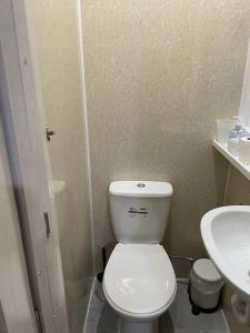 a bathroom with a white toilet and a sink at Leman House in London