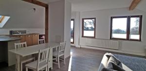 a kitchen and living room with a table and chairs at Haus Stella am Meer in Rerik