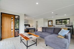 a living room with a couch and a table at Goolwa River Retreat in Torrumbarry